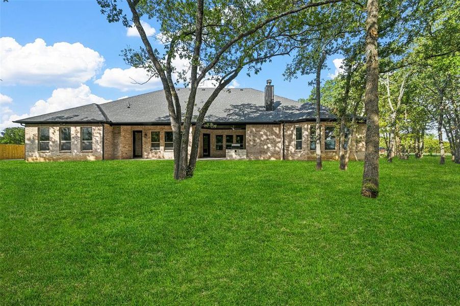 Rear view of house featuring a yard