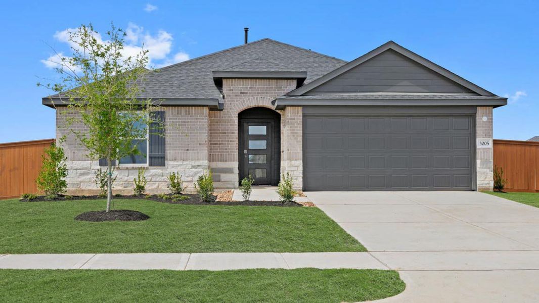 Front exterior of a new home in Sunterra Lakes, Brookshire, TX, highlighting curb appeal (Image 17).