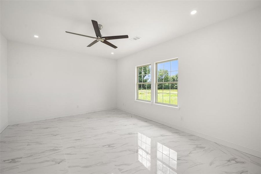 Empty room with light marble finish flooring, ceiling fan, and recessed lighting Empty room with light marble finish flooring, ceiling fan, and recessed lighting