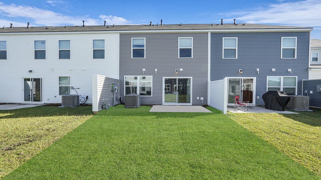 Exterior details and patio area of a home in Pine Hills Townhomes at Cane Bay, Summerville (Image 21).