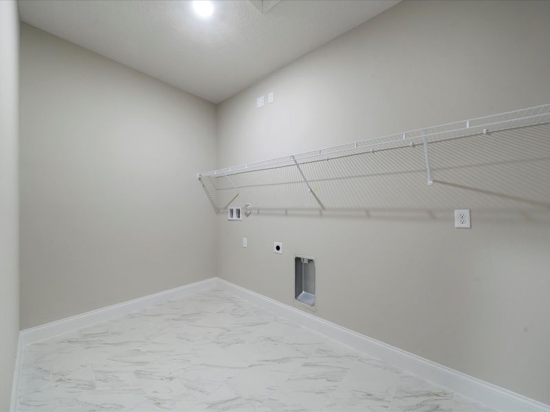 Laundry Room in the Coral floorplan at 6295 NW Sweetwood Drive in Brystol at Wylder