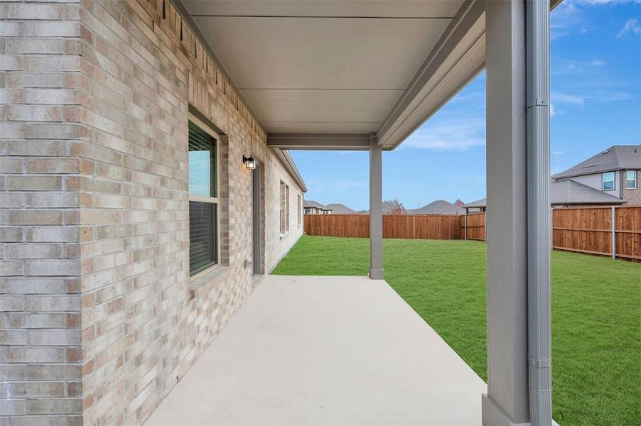 Exterior details and patio area of a home in The Preserve, Justin (Image 19).