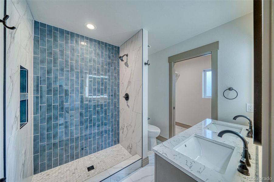 En suite in the primary. Large shower and dual sinks makes this easy and convenient.
