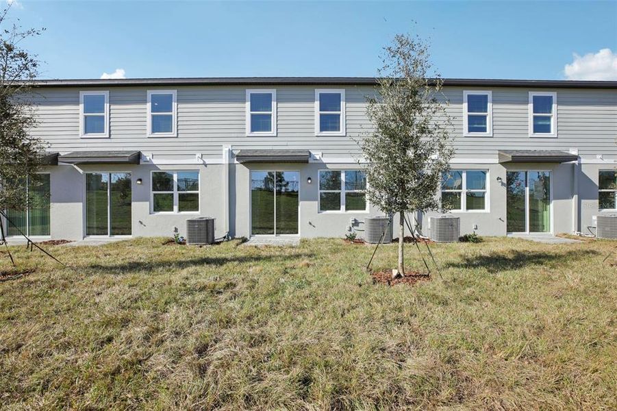 Exterior details and patio area of a home in The Reserve at Hammock Oaks Townes, Lady Lake (Image 28).