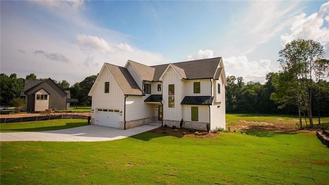 Front exterior of a new home in , Flowery Branch, GA, highlighting curb appeal (Image 29).