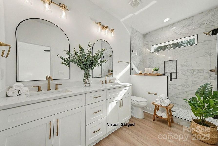This shower offers a spa-like experience with its elegant tiling, clear glass enclosure, and the added benefit of a transom window, allowing ample natural light to flood the space. This shower offers a spa-like experience with its elegant tiling, clear glass enclosure, and the added benefit of a transom window, allowing ample natural light to flood the space.