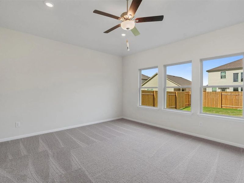 A spacious bedroom provides a comfortable retreat with ample natural light.