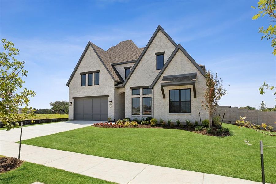 Light colored brick with dark accents create a striking home with tons of curb appeal!