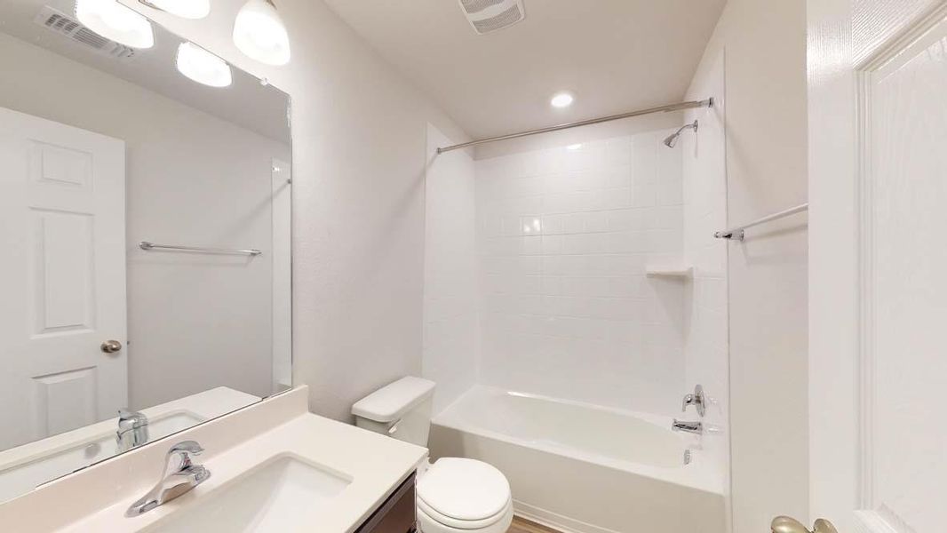 Full bathroom with shower / bath combination, vanity, and recessed lighting