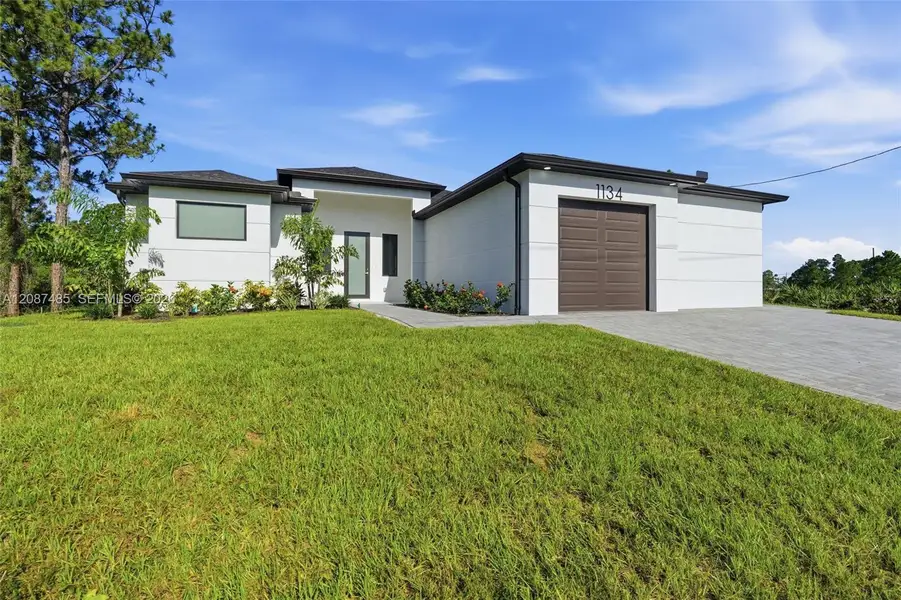 Front exterior of a new home in , Lehigh Acres, FL, highlighting curb appeal (Image 1). Front exterior of a new home in , Lehigh Acres, FL, highlighting curb appeal (Image 1).