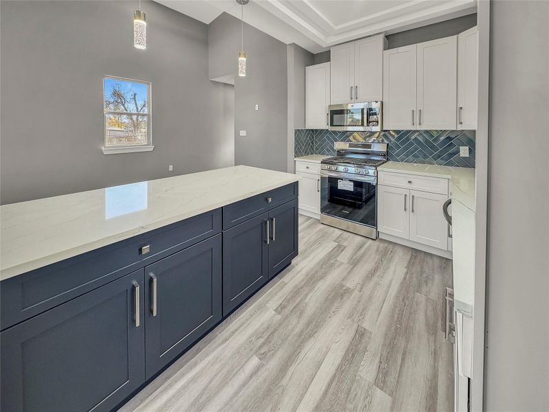 Modern kitchen with sleek cabinetry and ample counter space