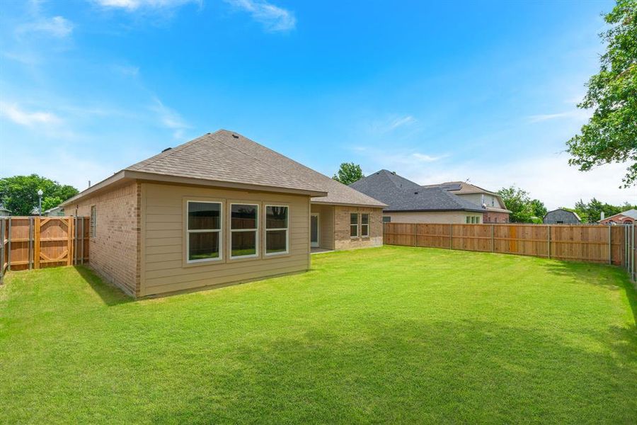 Back of house featuring a yard