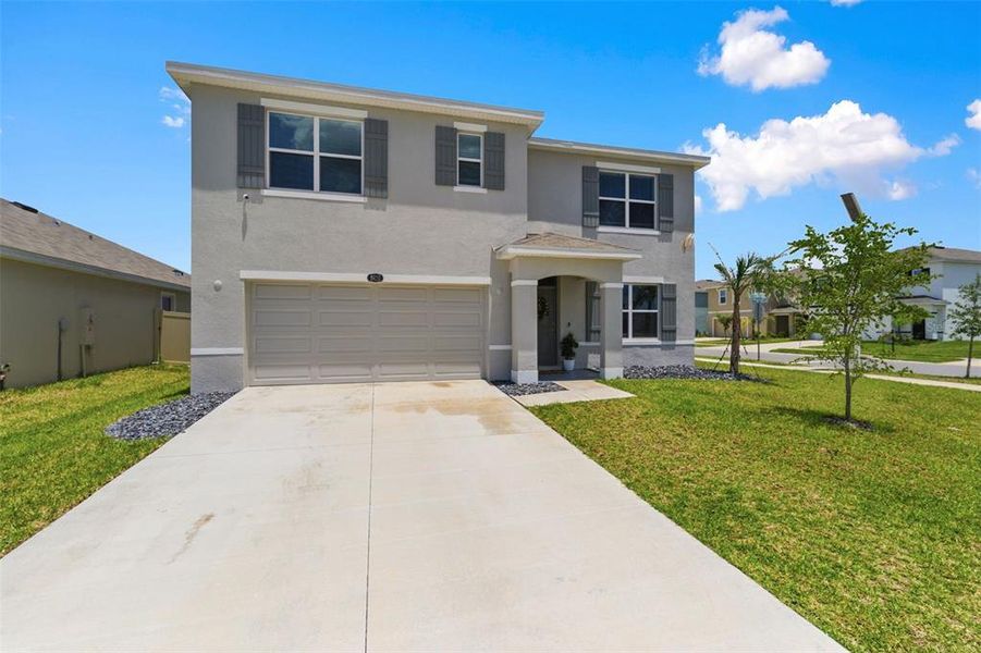 Front exterior of a new home in Epperson, Wesley Chapel, FL, highlighting curb appeal (Image 2). Front exterior of a new home in Epperson, Wesley Chapel, FL, highlighting curb appeal (Image 2).