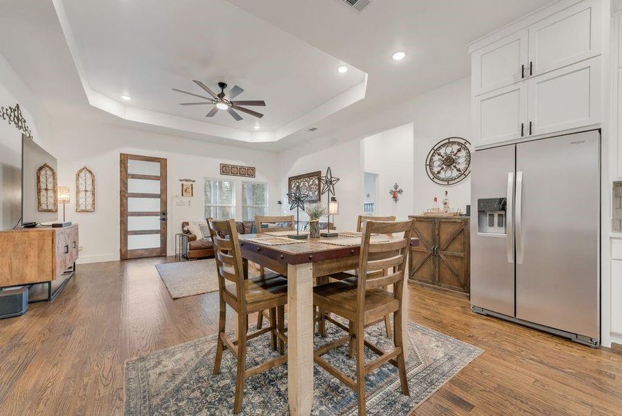 Dining space with ceiling fan, light wood-style flooring, and recessed lighting