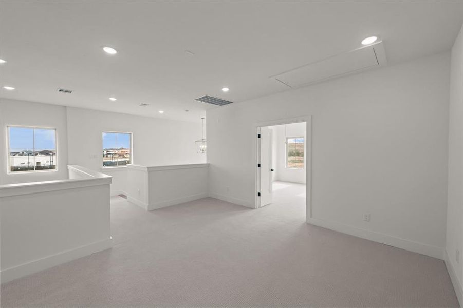 Carpeted empty room featuring plenty of natural light