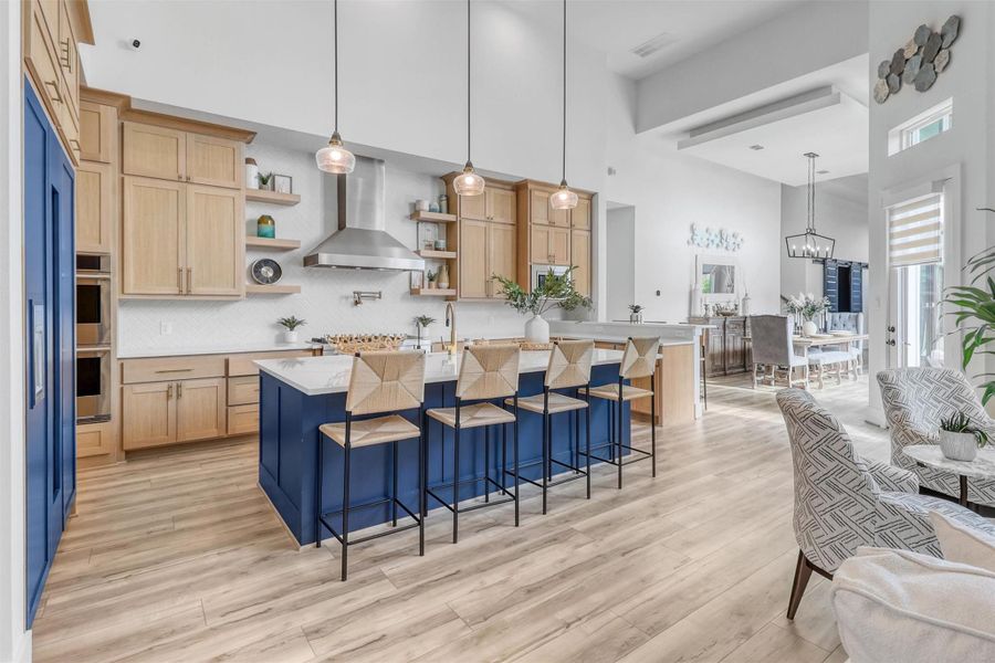 If you can believe it, this kitchen is even more stunning in person! Large center island, quartz countertops, breakfast bar, pendant lighting, chevron tile backsplash, gas stovetop, double ovens, pot filler, stainless steel vent hood, elegant gold accents, this is a dream kitchen come true!