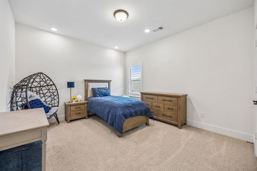 Bedroom featuring light carpet and recessed lighting