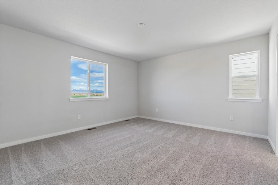 A room with a window and a carpet.
