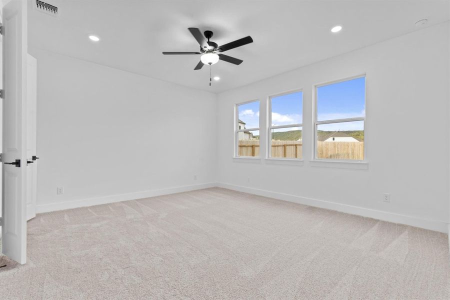 Spare room featuring ceiling fan and light colored carpet