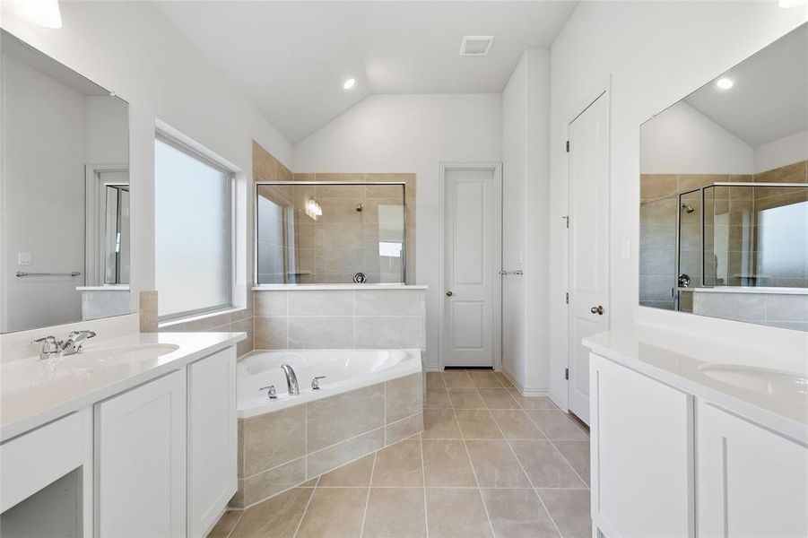 Bathroom with two vanities, a bath, light tile patterned floors, a shower stall, and recessed lighting