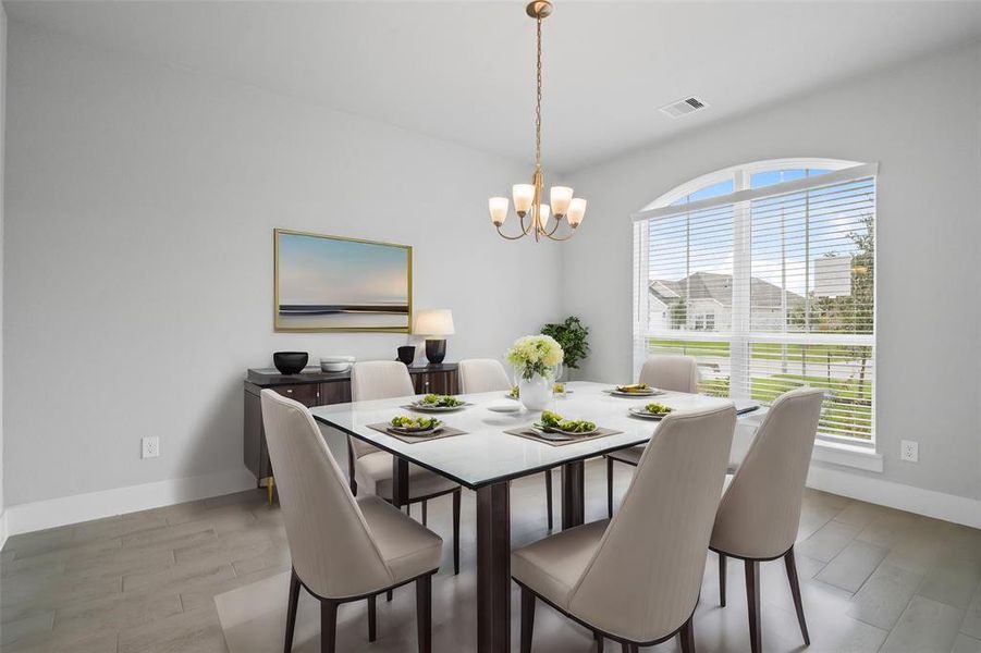 You and your guests will certainly dine in style in this amazing formal dining room! Featuring a gorgeous chandelier, arched windows with blinds, neutral paint and high ceilings.