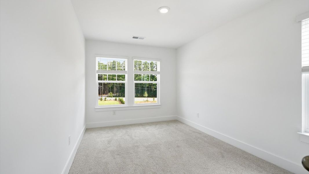 Refined bedroom design with large windows for daylight-filled mornings and peaceful views at Barton Hollow