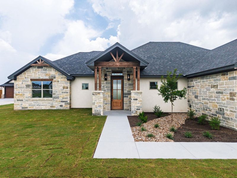 A graceful stone and stucco façade defines this home's inviting curb appeal. A graceful stone and stucco façade defines this home's inviting curb appeal.