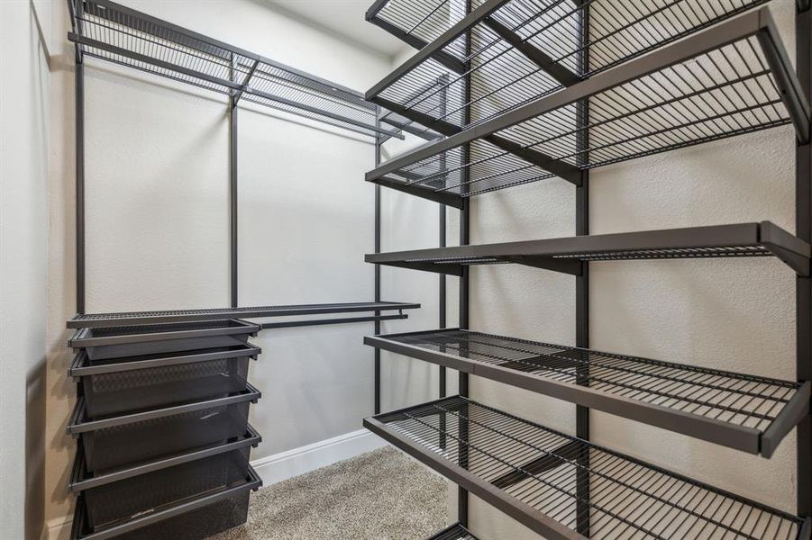 Primary bedroom walk in closet with organization Primary bedroom walk in closet with organization