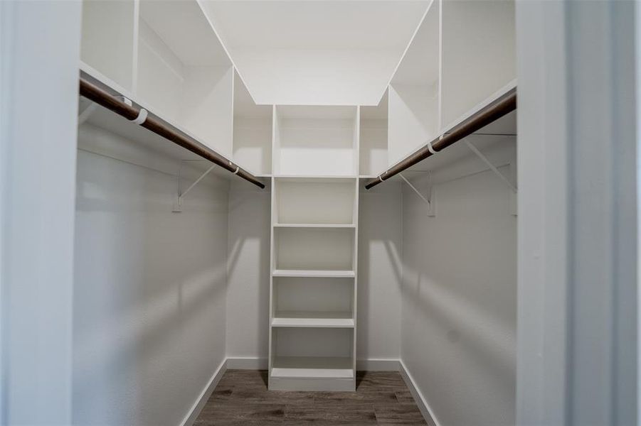 Walk in closet with dark wood-style floors Walk in closet with dark wood-style floors