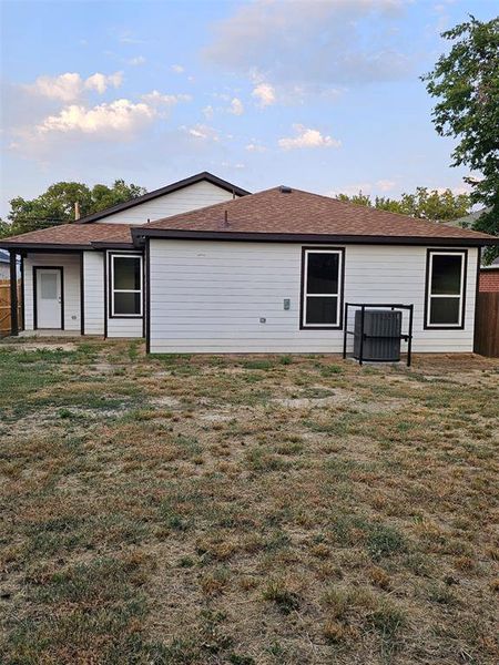 Rear view of property featuring a yard