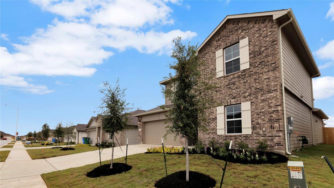 Front exterior of a new home in Carillon, Manor, TX, highlighting curb appeal (Image 17).