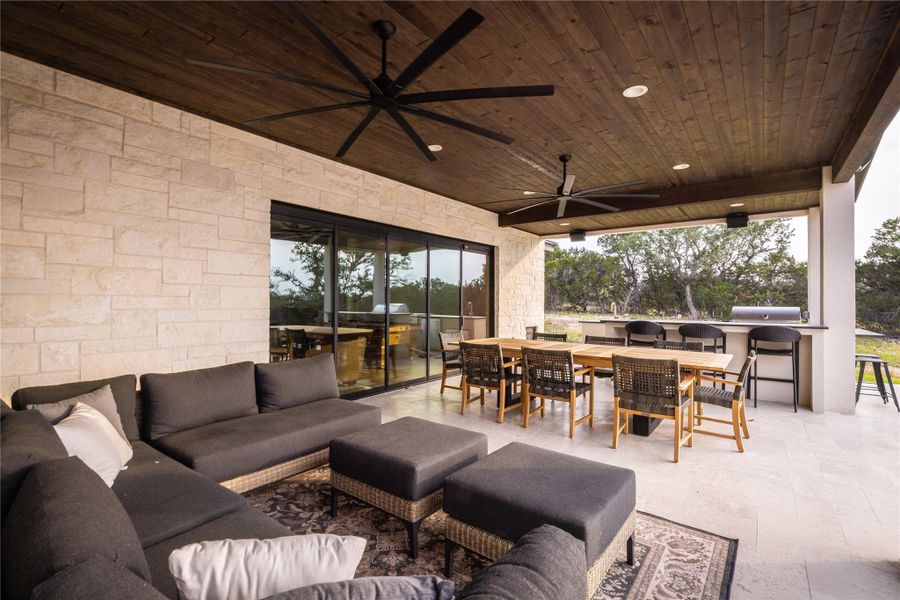 View of patio featuring ceiling fan and an outdoor living space