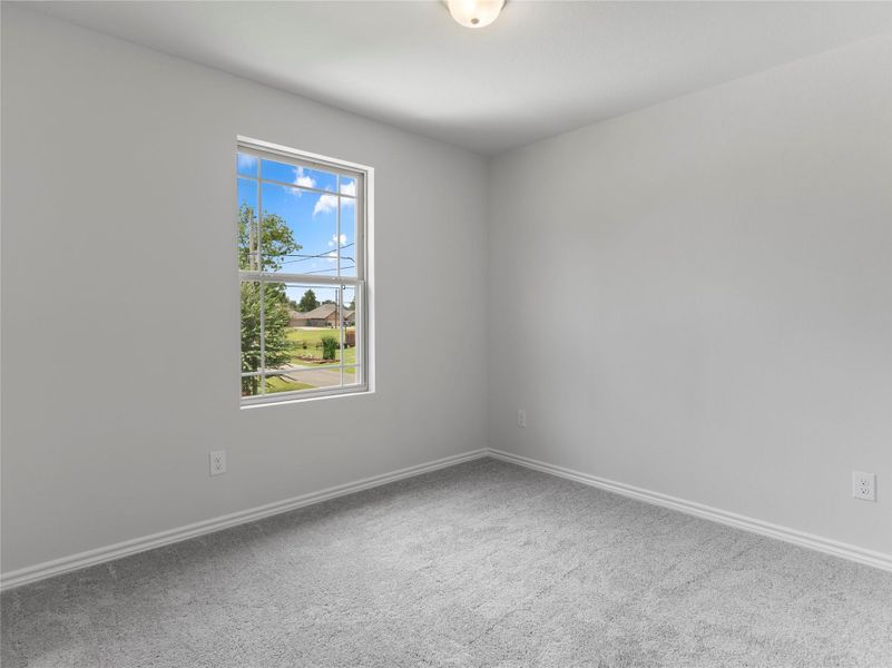 Upstairs third bedroom featuring cozy carpeting. Upstairs third bedroom featuring cozy carpeting.