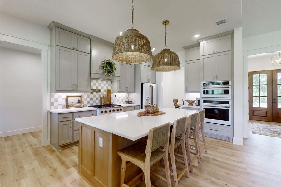 Kitchen with gray cabinetry, white appliances, decorative backsplash, and recessed lighting