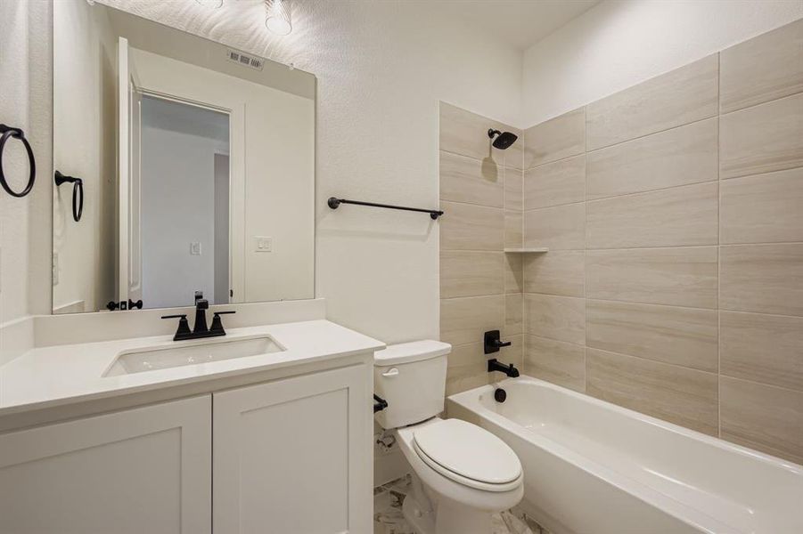 Bathroom featuring washtub / shower combination and vanity Bathroom featuring washtub / shower combination and vanity