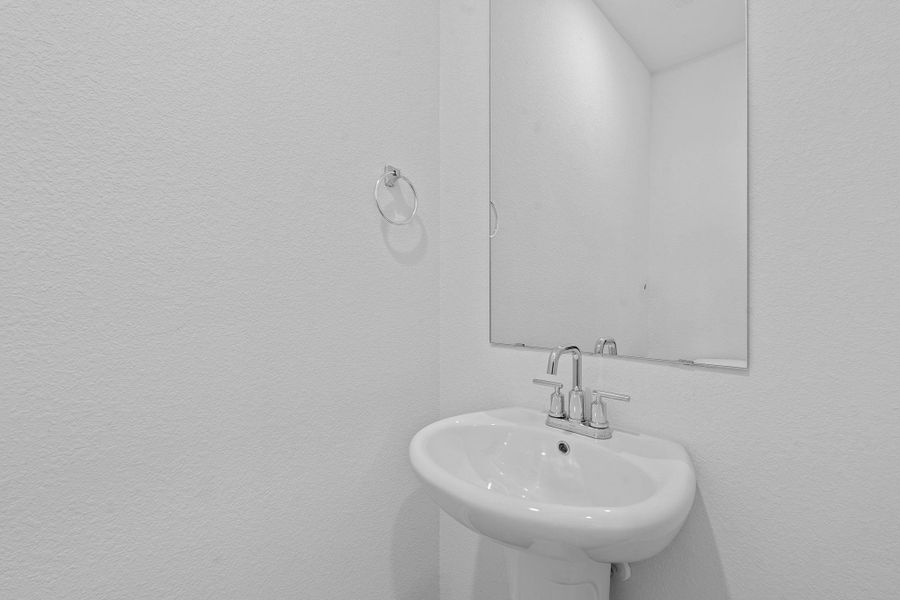 Bathroom with a textured wall and a sink Bathroom with a textured wall and a sink