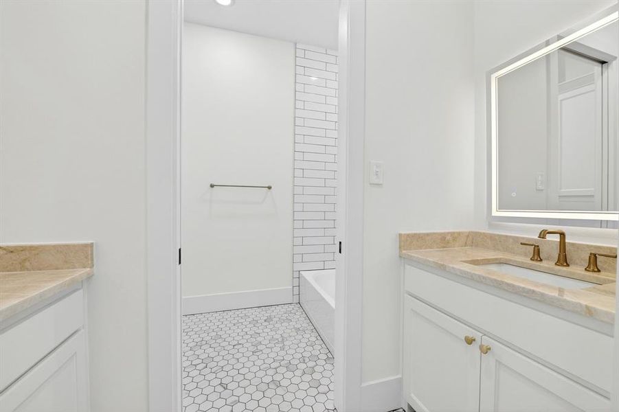 One of bathrooms located downstairs with 2 separate sink areas