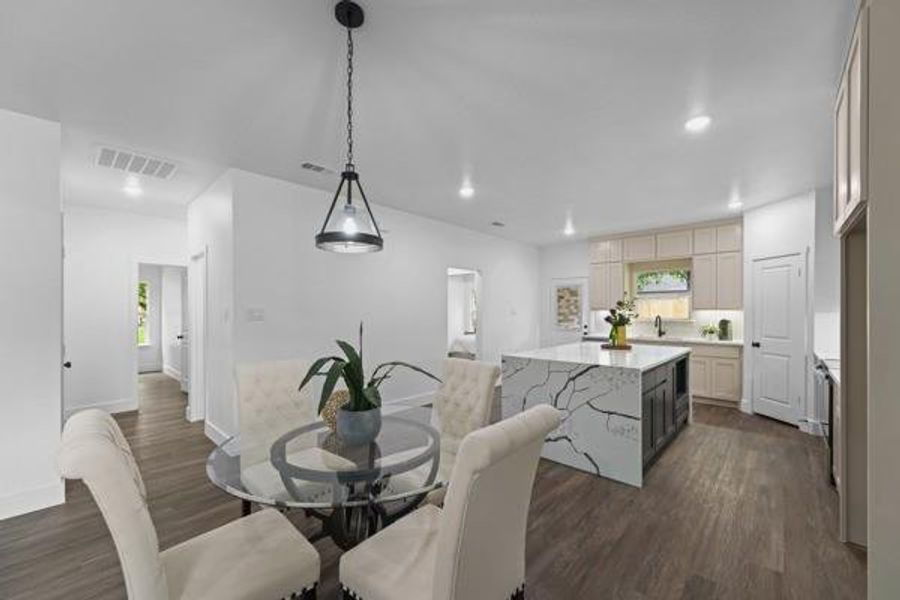 Open-concept kitchen and dining area featuring wood-finish flooring Open-concept kitchen and dining area featuring wood-finish flooring