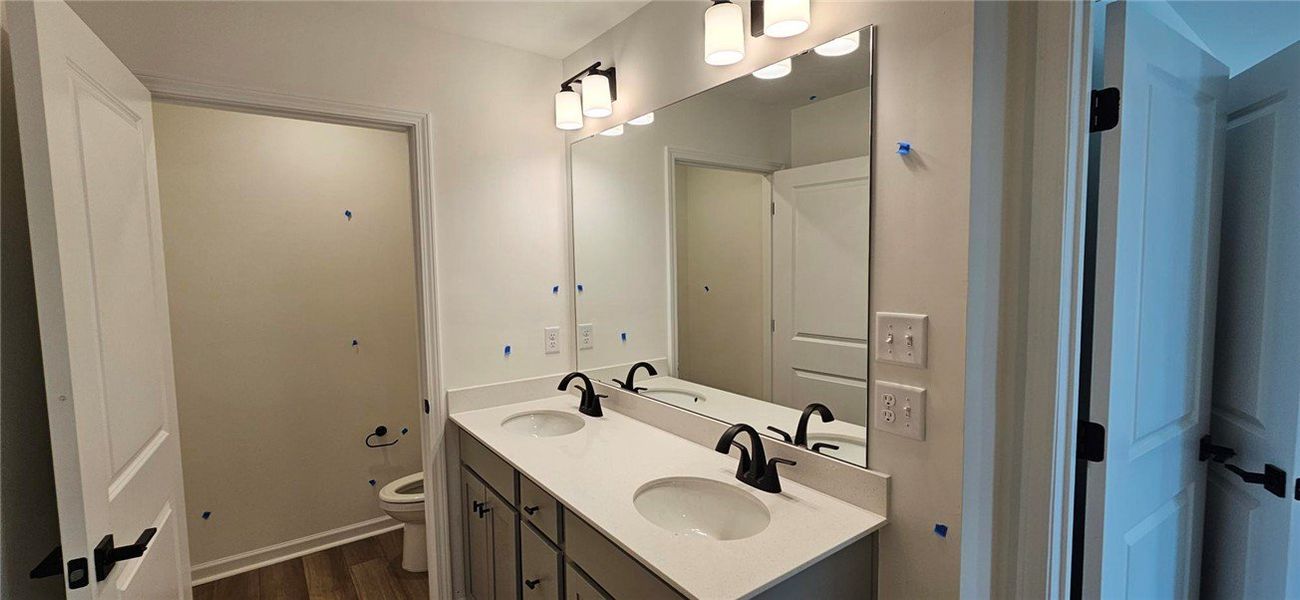 This spacious bathroom features a double vanity an This spacious bathroom features a double vanity an