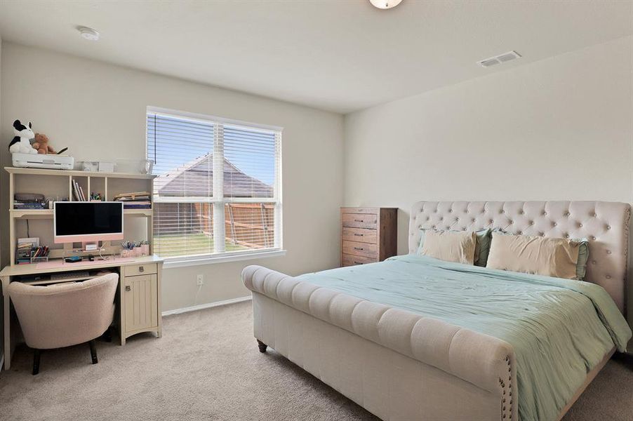 Bedroom featuring light colored carpet