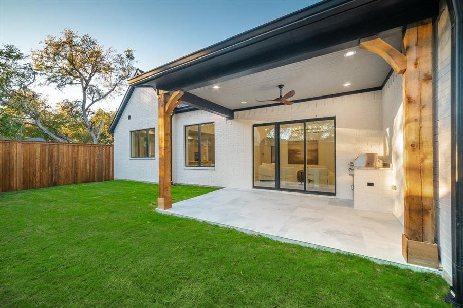 Rear view of property featuring a ceiling fan, a patio area, a fenced backyard, and brick siding Rear view of property featuring a ceiling fan, a patio area, a fenced backyard, and brick siding