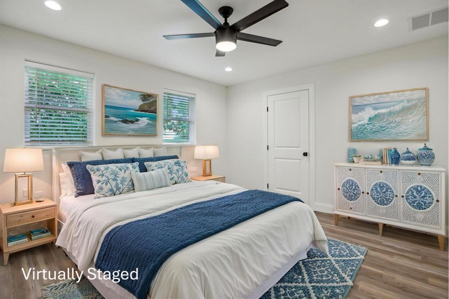 Virtually Staged Primary Bedroom featuring recessed lighting, vinyl wood plank floors, visible vents, and a ceiling fan