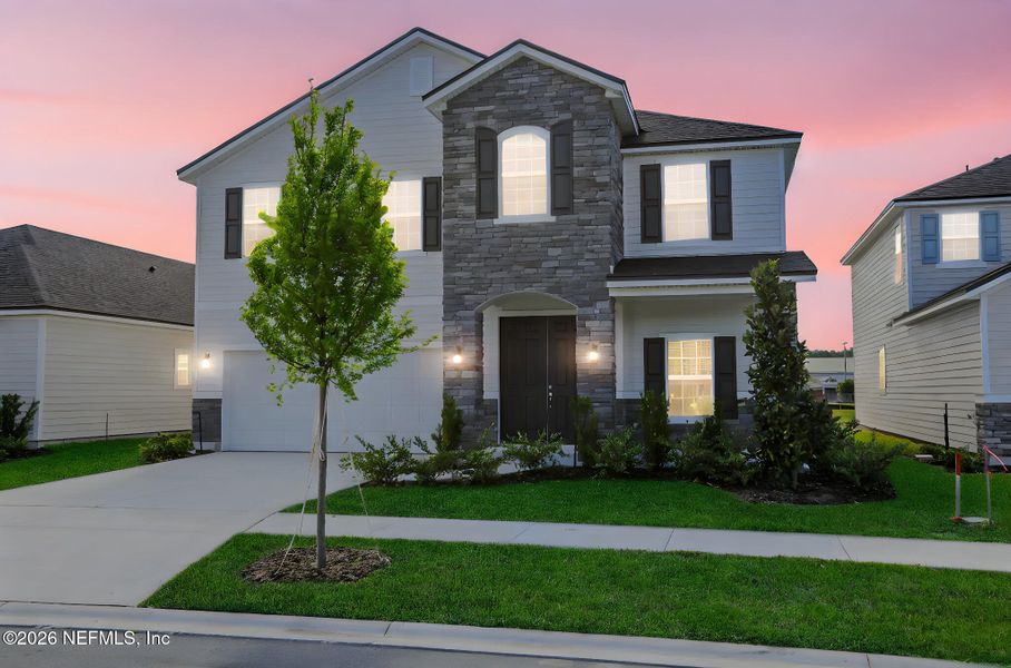 Front exterior of a new home in Amberly, Green Cove Springs, FL, highlighting curb appeal (Image 24).
