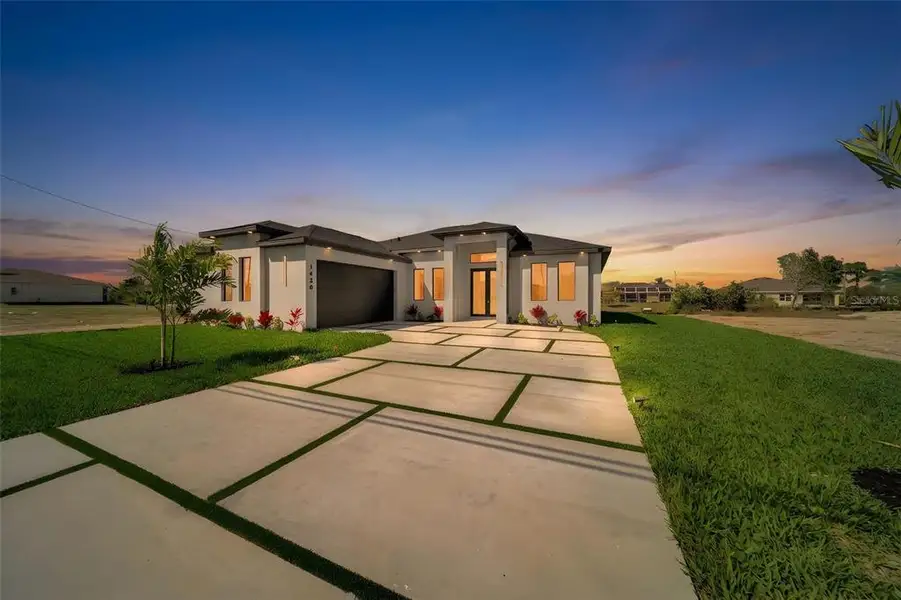 Front exterior of a new home in , Cape Coral, FL, highlighting curb appeal (Image 2). Front exterior of a new home in , Cape Coral, FL, highlighting curb appeal (Image 2).