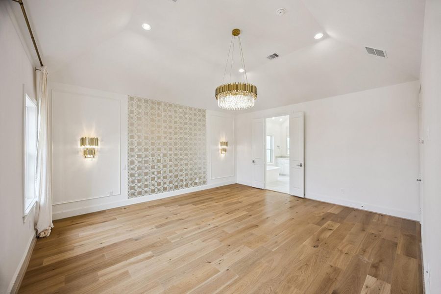 Another view of the generously sized primary suite with elevated ceiling detail.