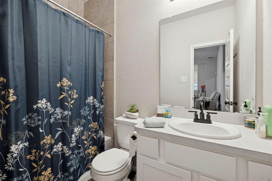 These rooms share a well-appointed full bathroom, perfect for family members or guests.