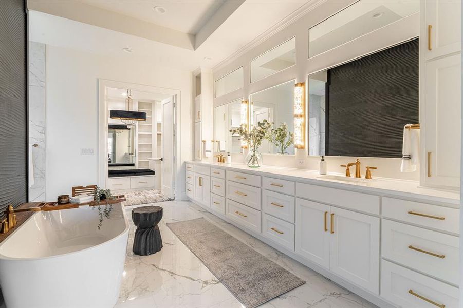 Bathroom featuring a tub to relax in, dual bowl vanity, and tile patterned flooring