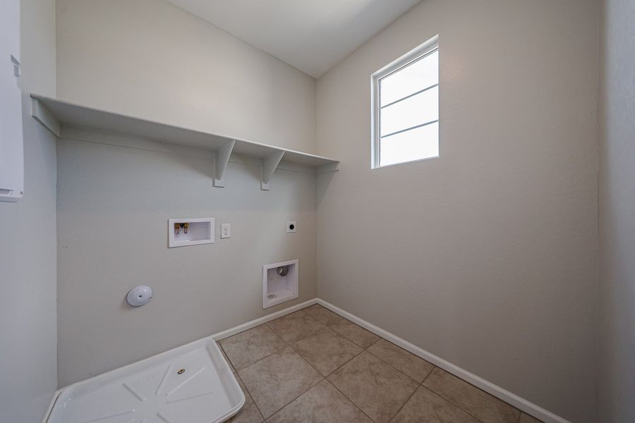 A room with a tile floor and a window.
