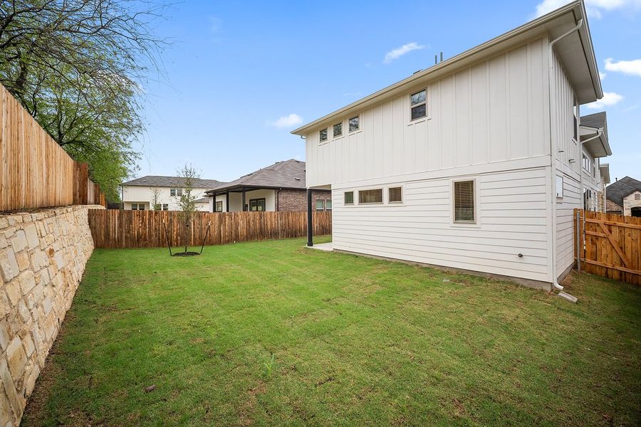 Front exterior of a new home in The Hills of Bear Creek, Manchaca, TX, highlighting curb appeal (Image 20).