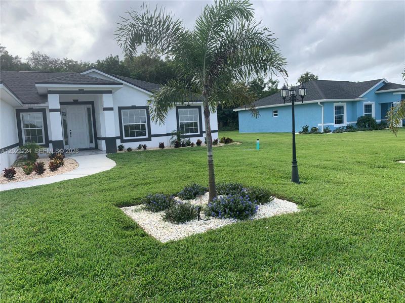Front exterior of a new home in , Lake Placid, FL, highlighting curb appeal (Image 17).